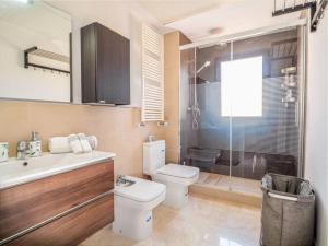a bathroom with a toilet and a sink and a shower at Villa HEIDI in Málaga