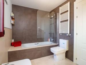 a bathroom with a tub and a toilet and a sink at Villa HEIDI in Málaga