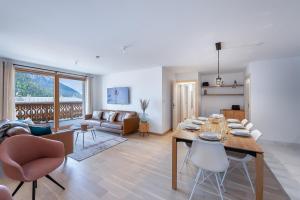 comedor y sala de estar con mesa y sillas en Perle de Savoie - Apt A103 - BO Immobilier, en Châtel