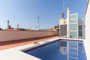 a swimming pool on the roof of a house at Aparteasy - Deluxe Family Apartments with Pool in Barcelona