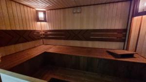 a bath tub with a wooden floor in a room at Shane Hotel Quba in Quba