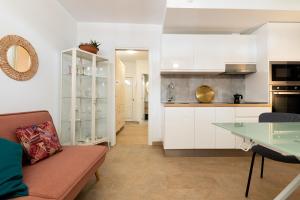 a kitchen and living room with a couch and a table at Quality and peaceful stay in Playa del Inglés in Playa del Ingles
