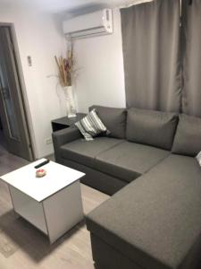a living room with a couch and a table at Casa Lexi in Mangalia