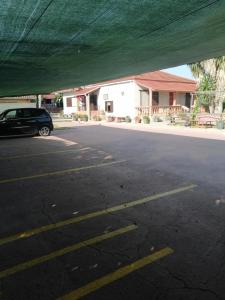 a parking lot with a car parked in front of a building at Armonia Studios in Agios Georgios
