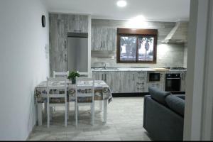 a kitchen with a table and a couch in a room at Villa la Parra in Chiclana de la Frontera