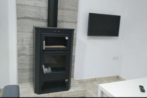 a black wood stove with a television in a room at Villa la Parra in Chiclana de la Frontera