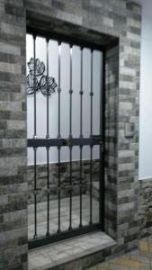 a door with a metal gate in a brick building at Villa la Parra in Chiclana de la Frontera