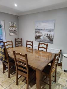 a dining room with a wooden table and chairs at 6 Connorville in Luddan