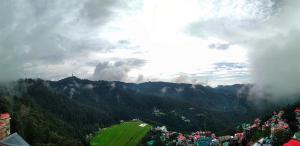 a view of a mountain with a crowd of people at Prairie Lodge in Shimla