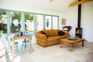a living room with a couch and a table at Fig Tree House in Penryn