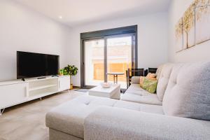 un salon avec un canapé et une télévision à écran plat dans l'établissement Alegria ID 11, à Torrevieja
