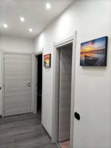 a hallway with a door and a painting on a wall at Sweet Apartment Mecenate in Milan