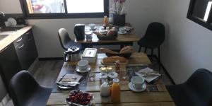 a table with food on it in a kitchen at La chambre du Clos Barriant in Séreilhac +9 photos