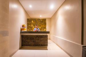 a man taking a picture in a room with a fireplace at Lili Cottage Ubud in Ubud