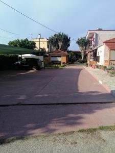 an empty street with a car parked in a driveway at Armonia Studios in Agios Georgios