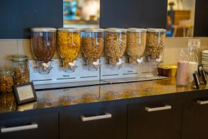 a bunch of glass jars filled with food on a counter at Hotel Bor in Krk