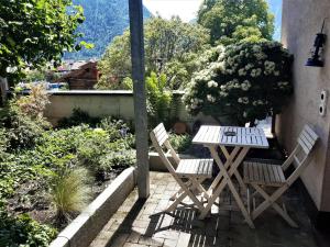 two chairs and a table on a patio at Jobling's Holiday Apartment in Interlaken