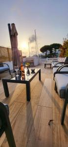 a table and chairs on a deck with a boat at Marina Sunset in Le Grau-du-Roi