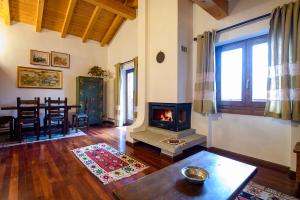 a living room with a fireplace and a table at Penthouse Center Madonna di Campiglio VN1 in Madonna di Campiglio