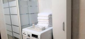 a bathroom with a stack of towels on a washing machine at Appartamento Garda Star in Cavalcaselle +23 photos