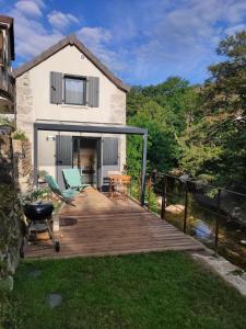 a wooden deck in front of a house at Le Secret du Moulin, agréable tiny house Villefort in Villefort