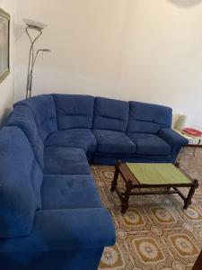 a blue couch in a living room with a coffee table at da Lilia in Salute&Bellezza Business Apartment in Monfalcone +136 photos