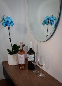 two bottles of wine and two glasses on a table at BIG BLUE HOTEL in Amaliapoli