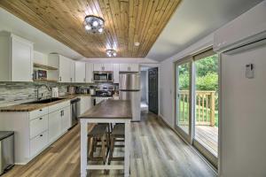 a kitchen with white cabinets and a wooden ceiling at Updated Bristol Retreat about 2 Miles to Downtown! in Bristol