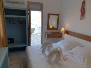 a bedroom with a bed with towels on it at St Paul's Studios Chrysanthi in Lindos