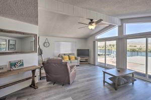a living room with a couch and a ceiling fan at Riverfront Bullhead City Home with Private Dock in Bullhead City