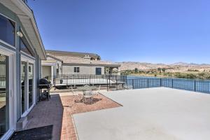 a patio with a view of a house at Riverfront Bullhead City Home with Private Dock in Bullhead City