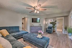 a living room with a couch and a ceiling fan at Quaint Downtown Murfreesboro Cottage with Lush Yard in Murfreesboro