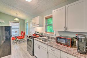 a kitchen with a sink and a counter top at Quaint Downtown Murfreesboro Cottage with Lush Yard in Murfreesboro