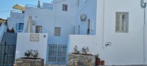 a white building with blue doors and windows at St Paul's Studios Chrysanthi in Líndos