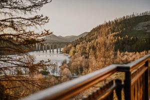 a view of a river with a bridge in the distance at Casa Boho in Fužine