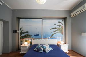a bedroom with a large window with a view of the ocean at Florinda B&B in Naples