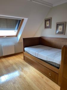 A bed or beds in a room at Apartamentos Villa Nustre