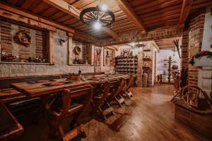 a large dining room with a long table and chairs at Casa Boho in Fužine