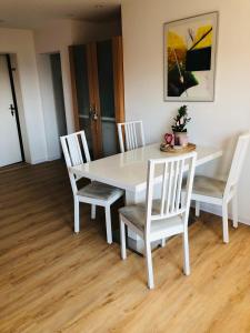 mesa de comedor blanca con 4 sillas y mesa en Ferienwohnung Marie, en Feldberg