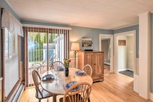 a dining room with a table and chairs and a kitchen at Kennebunk Home with Yard Less Than 1 Mile to Dock Square! in Kennebunk