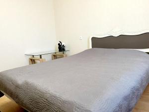 a bedroom with a large bed with a white headboard at M&M Apartment V SELF CHECK-IN in Panevėžys