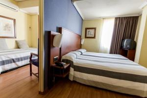 a hotel room with a bed and a window at Torreluz Apartamentos in Almería