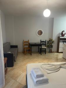 a living room with a couch and a table at Kokomani in Durrës +6 photos