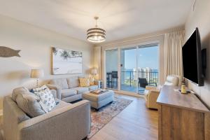 a living room with a couch and a tv at WS Luxury Condo of Seascape in Destin