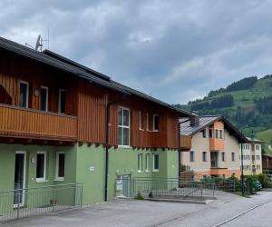 a group of houses in a town with mountains in the background at Apartment Heijerhof - Top 4 in Wagrain