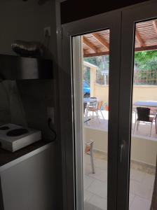 a sliding glass door with a view of a patio at San Pedro in Vasiliki