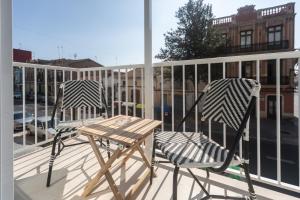 a pair of chairs and a table on a balcony at Reinapart Valencia Beach in Valencia
