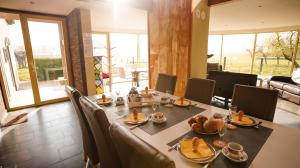 a dining room with a table with food on it at Villa Corthals in Brakel