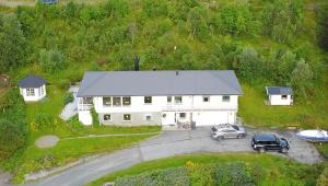 an aerial view of a white house with a car at Apartment on Whaleisland in Sjurdnes