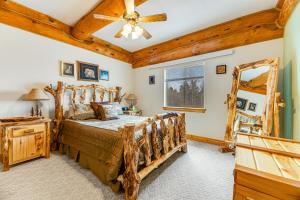 a bedroom with a wooden bed and a ceiling fan at Tetro Rock Retreat in Deadwood +31 photos